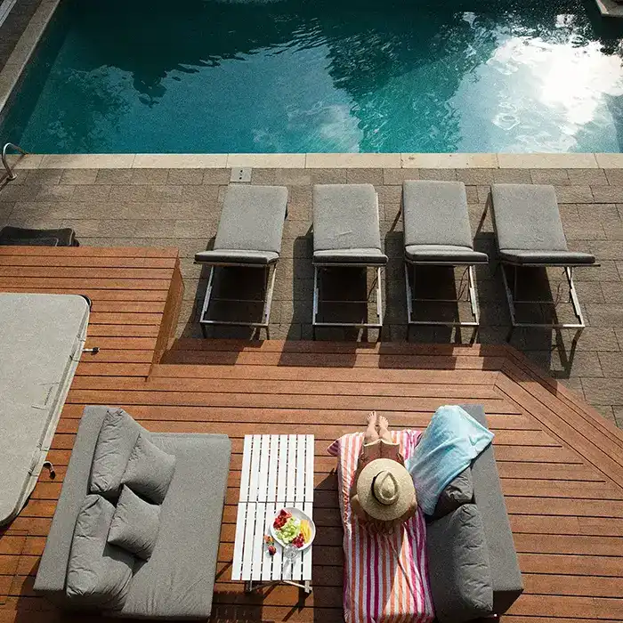 woman on a deck with a pool